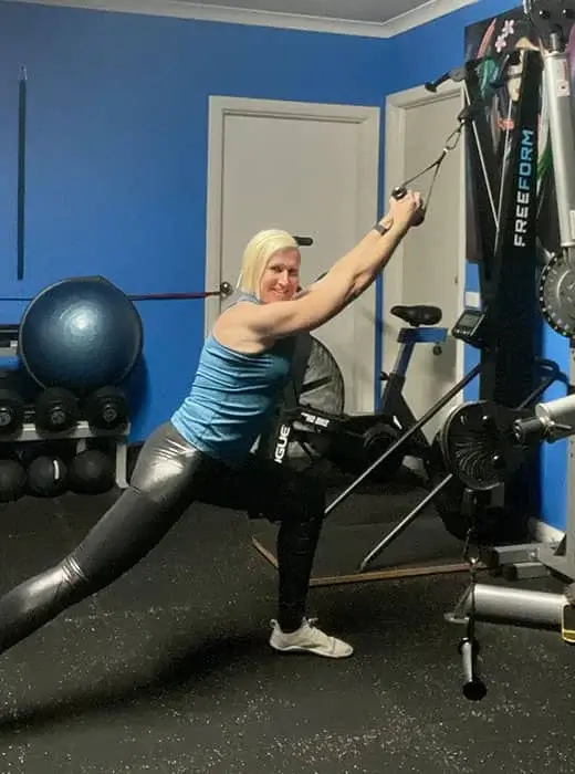 A certified fitness trainer performs a low row exercise